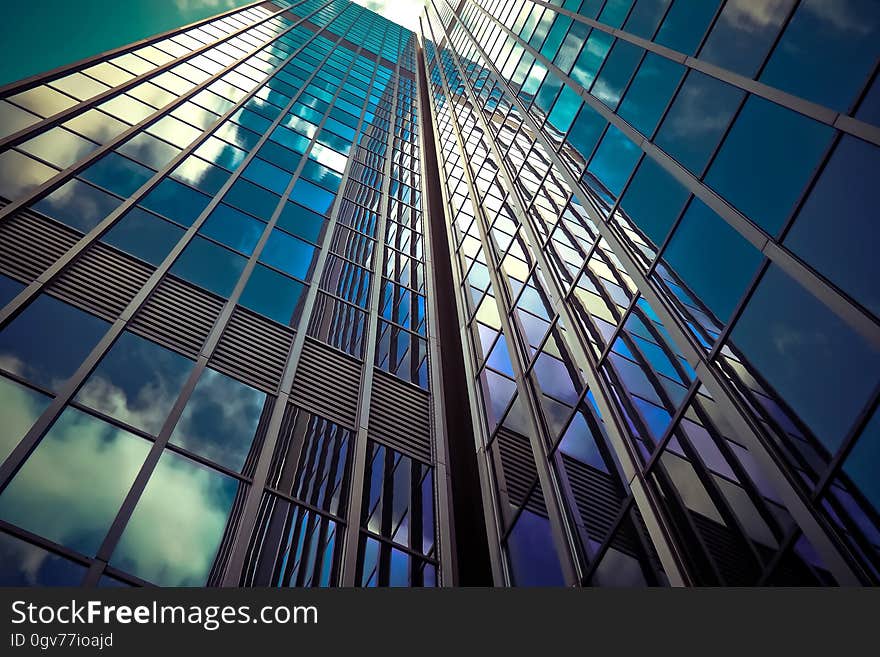 A modern glass skyscraper from a low angle.