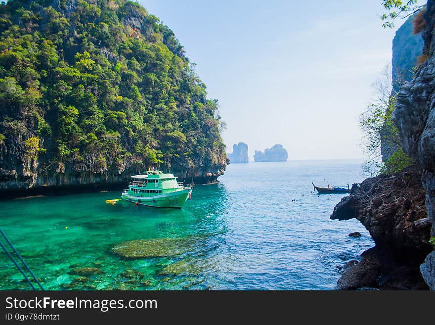 White Ship Sailed in Ocean Near Island