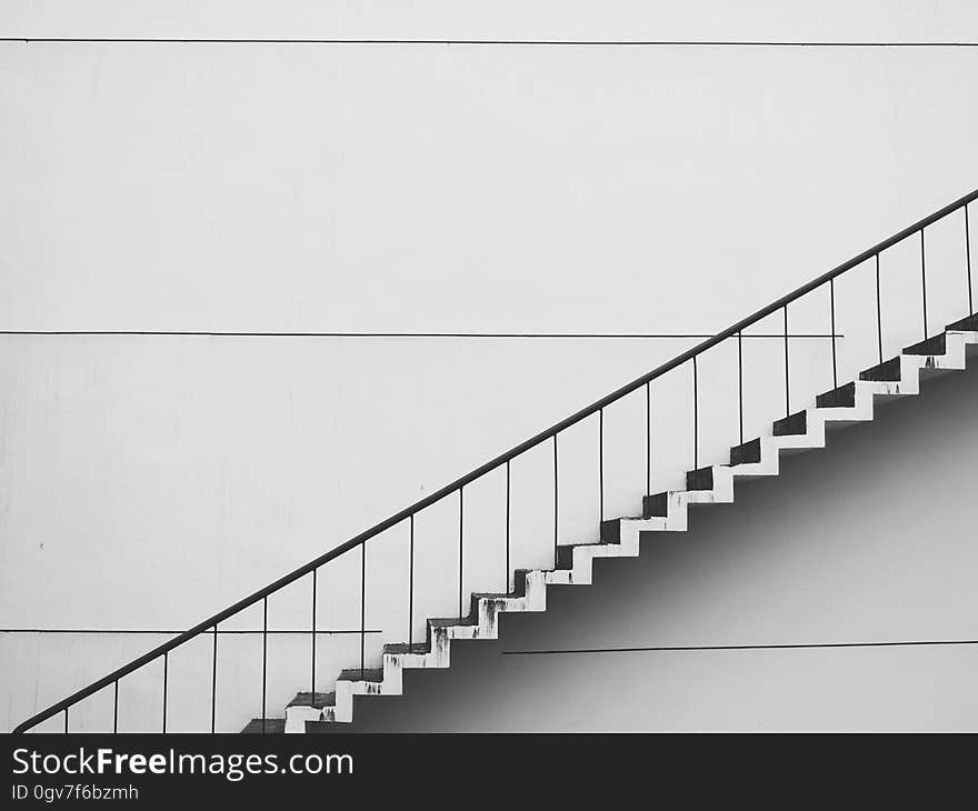 A staircase against a white wall.