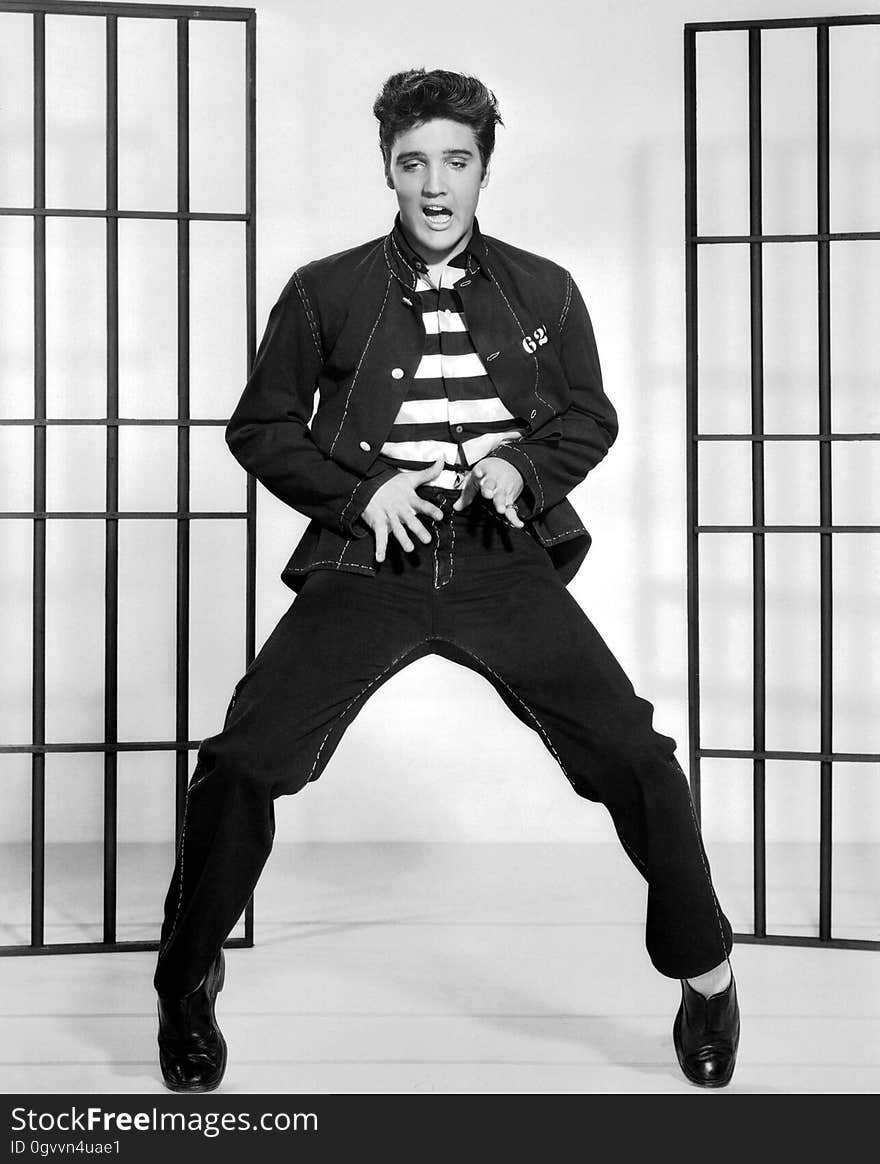 A black and white photo of Elvis Presley dancing in jail.