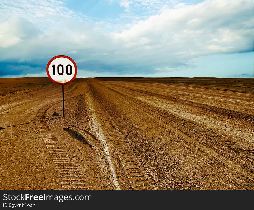 A desert landscape with a speed limit sign. A desert landscape with a speed limit sign.