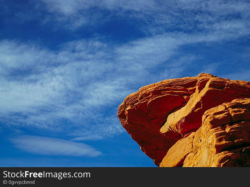 A sandstone rock with a blue sky in the background.