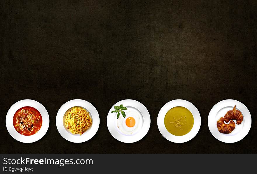 Five White Plates With Different Kinds of Dishes