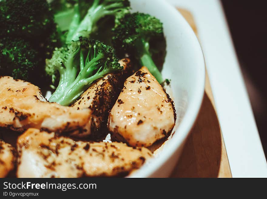 A pot with chicken and broccoli cooking.