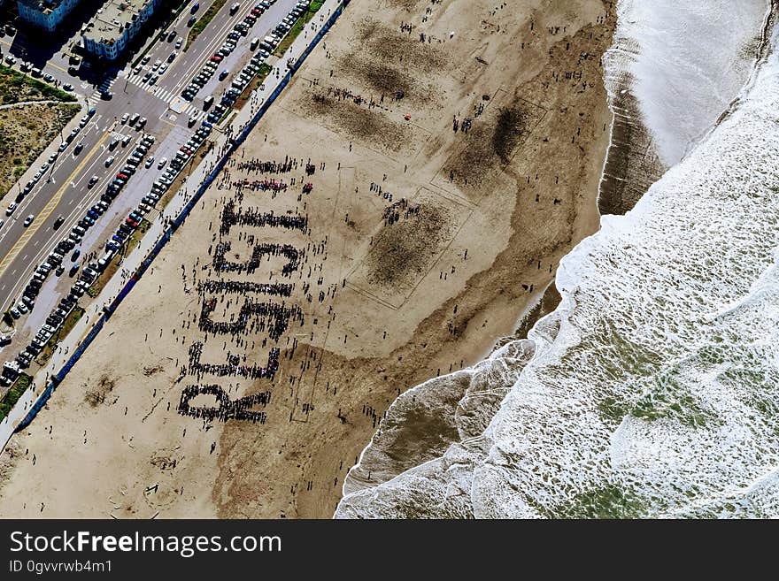 The word "resist" written on beach seen from the air.