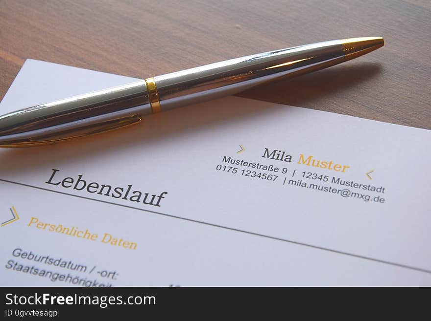 Pen resting on top of a German business document. Pen resting on top of a German business document.