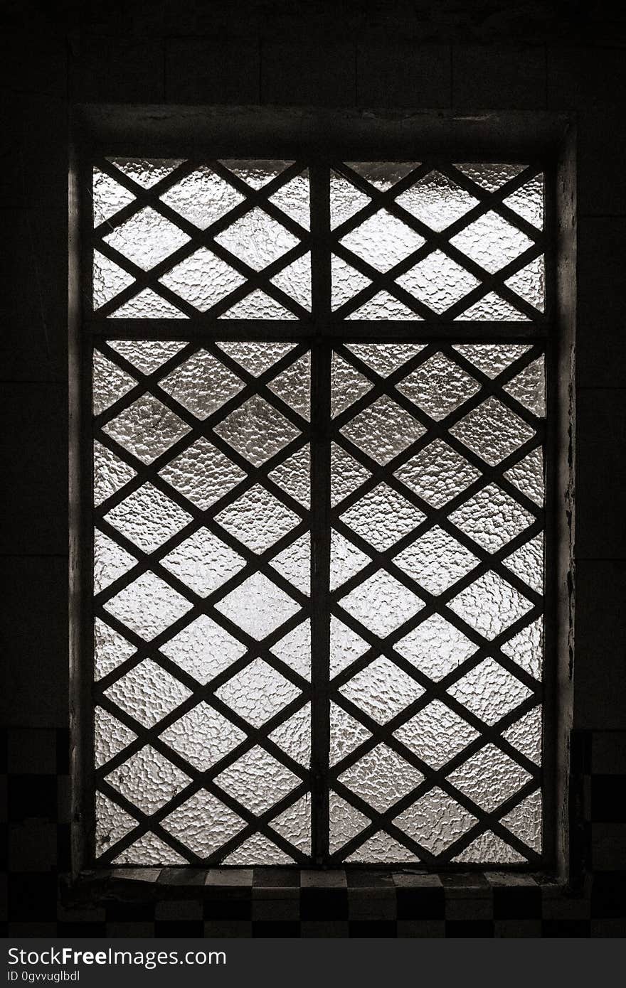 Metal bars over opaque glass windows in frame in black and white. Metal bars over opaque glass windows in frame in black and white.