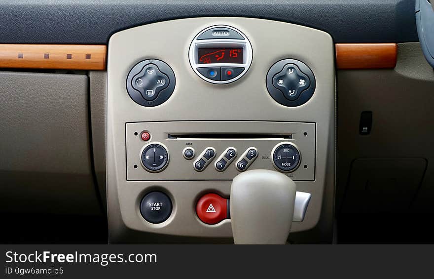 The central console of a car with media player and air conditioner controls. The central console of a car with media player and air conditioner controls.