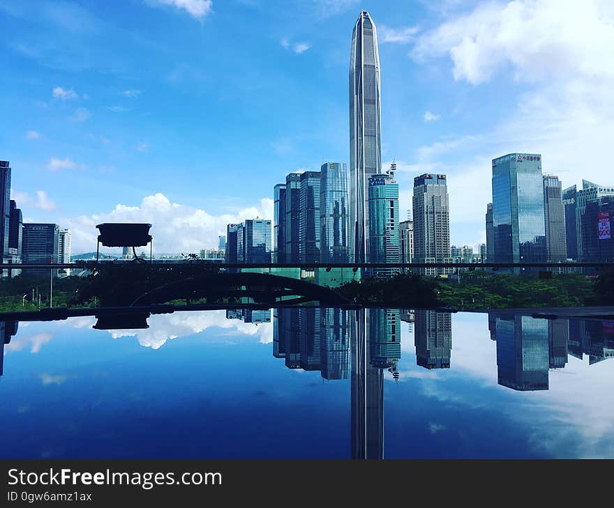 Modern skyscrapers reflecting on a still water surface. Modern skyscrapers reflecting on a still water surface.