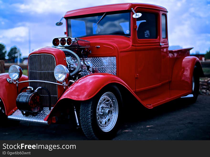 A red retro car parked outdoors.