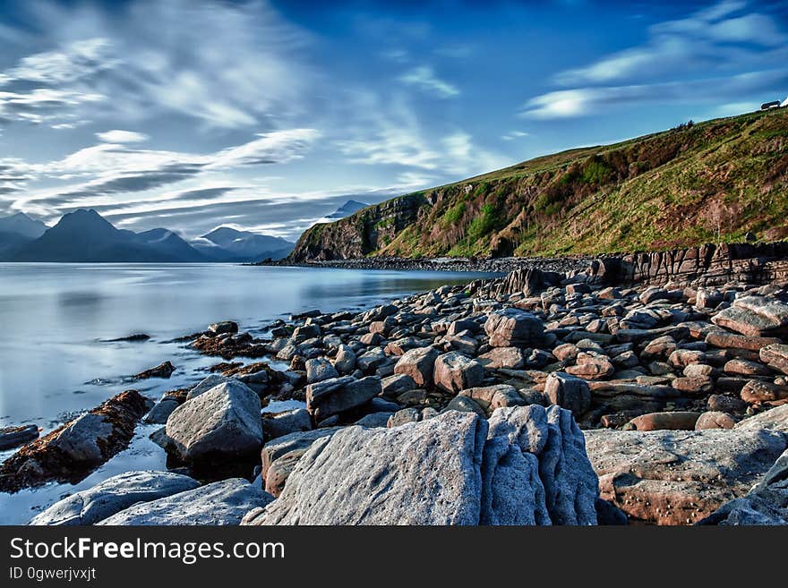 Big Rocks Near Ocean Under Blue Sky