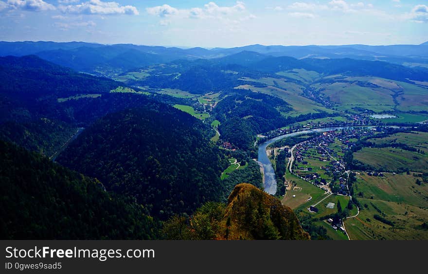 Aerial view of mountains and river curving through countryside. Aerial view of mountains and river curving through countryside.