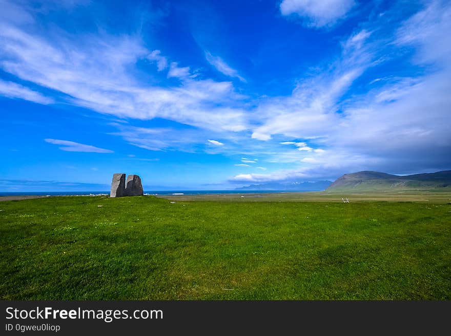 Dramatic blue skies over green fields in countryside on sunny day. Dramatic blue skies over green fields in countryside on sunny day.