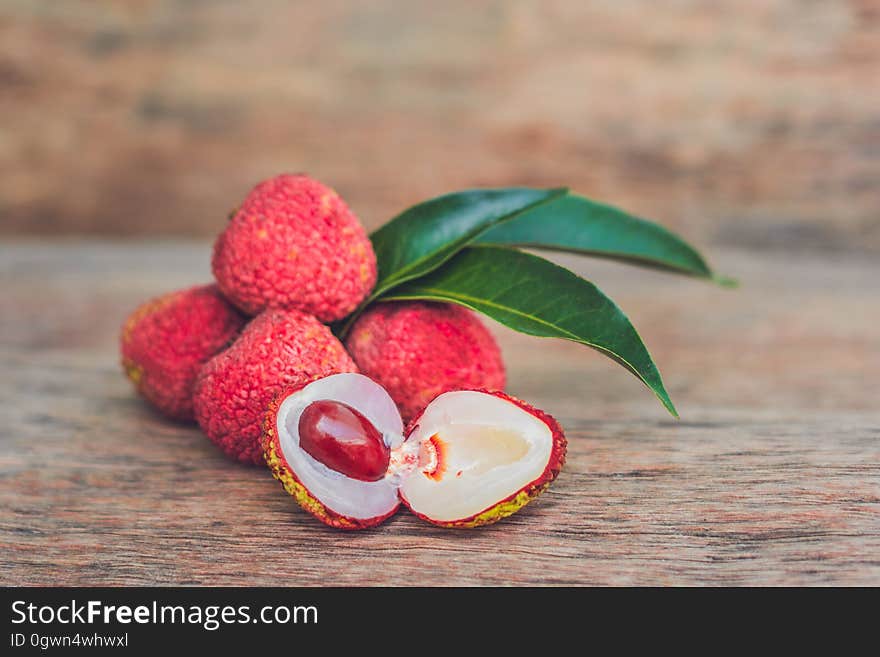 Fresh litchi fruit on an old wooden background