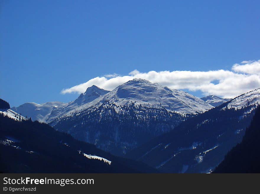 A view of mountain peaks covered in snow.