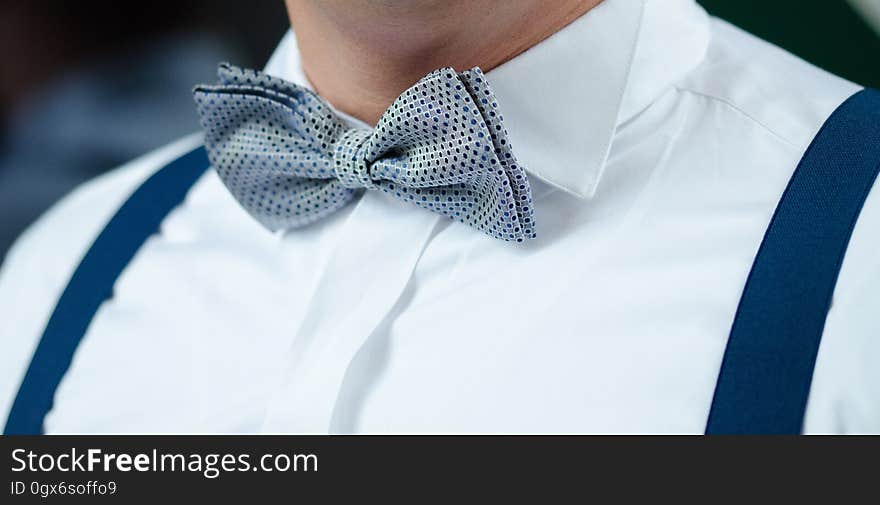 Man in White Dress Shirt Blue Suspenders and Gray Polka Dotted Bowtie