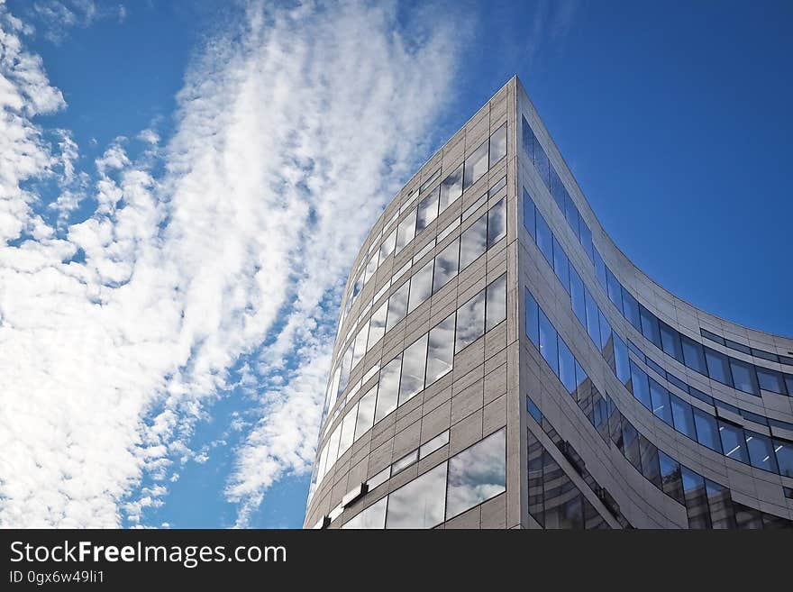 A modern office building and the sky in the background.