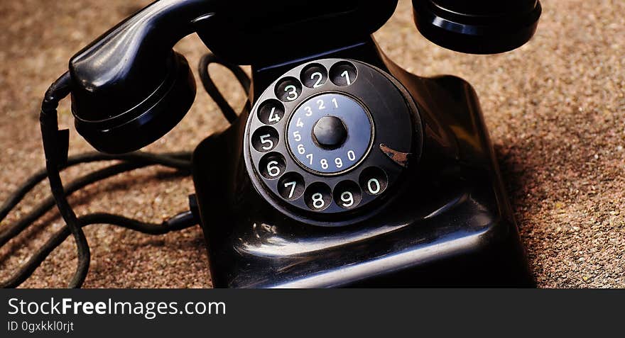 Antique rotary dial phone in black. Antique rotary dial phone in black.