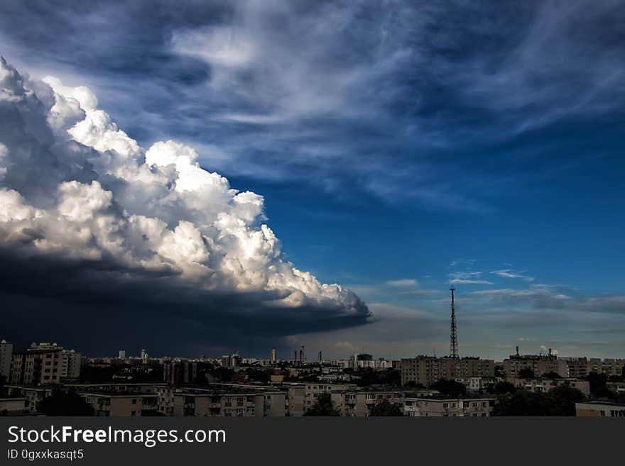 White Concrete High Rise Building Under Gray White Clouds during Daytime