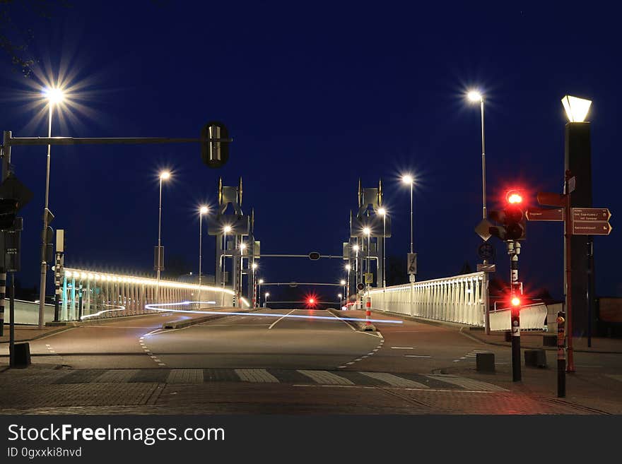 Urban road bridge illuminated at night, viewed from a low angle. Urban road bridge illuminated at night, viewed from a low angle.