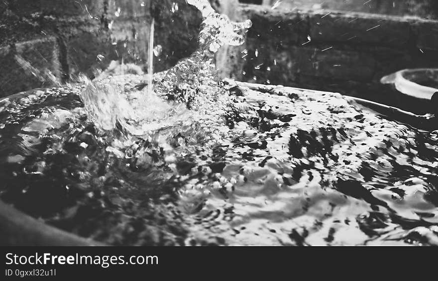 Close up of flowing and splashing water in black and white.