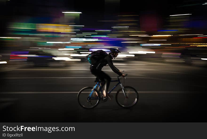 Photo Lapse Photo of Man Riding a Road Bicycle