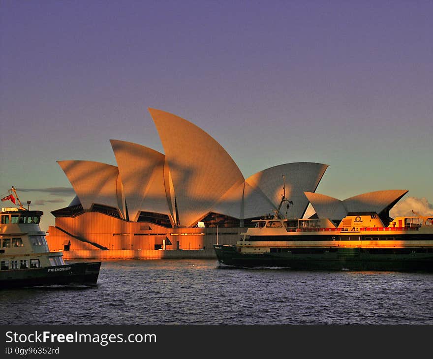 Sydney Opera House with the shadow of the Harbor bridge on it at sun set, Sydney, Australia. Sydney Opera House with the shadow of the Harbor bridge on it at sun set, Sydney, Australia