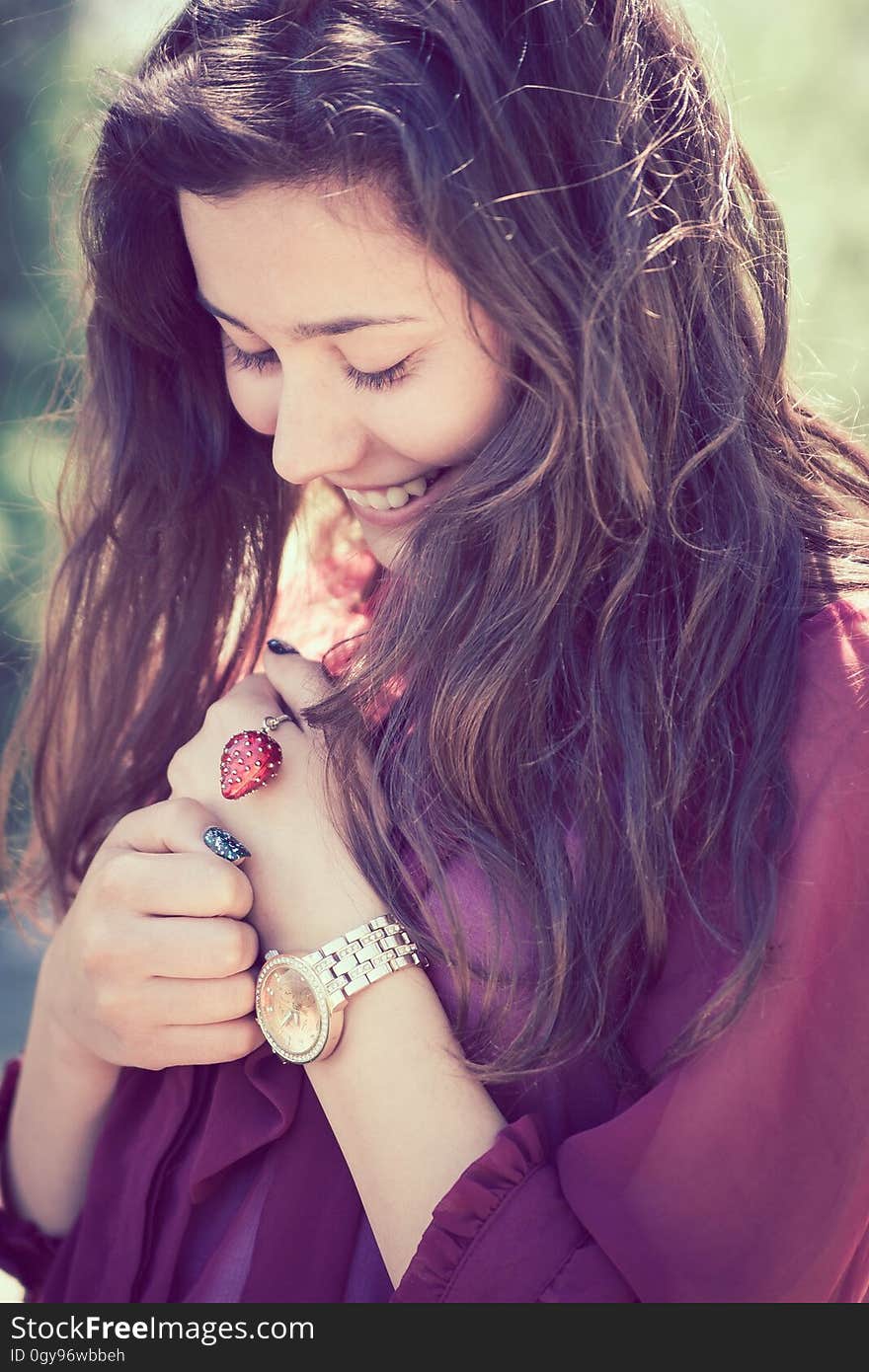 Portrait of long haired brunette woman outdoors smiling. Portrait of long haired brunette woman outdoors smiling.