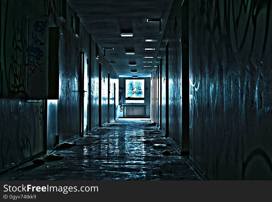 Hallway illuminated with blue lights inside abandoned building. Hallway illuminated with blue lights inside abandoned building.