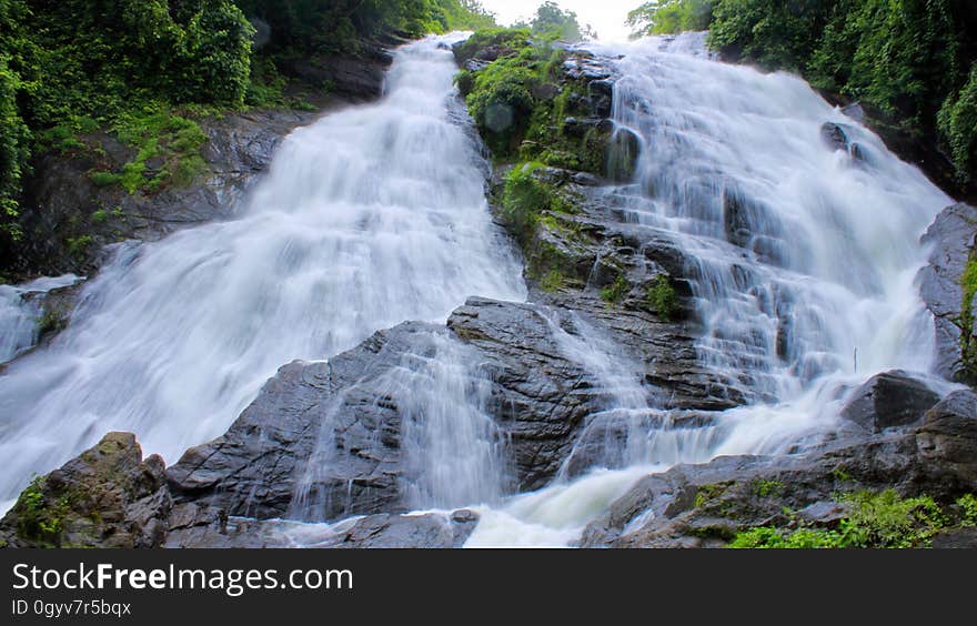 A waterfall cascading over boulders. A waterfall cascading over boulders.