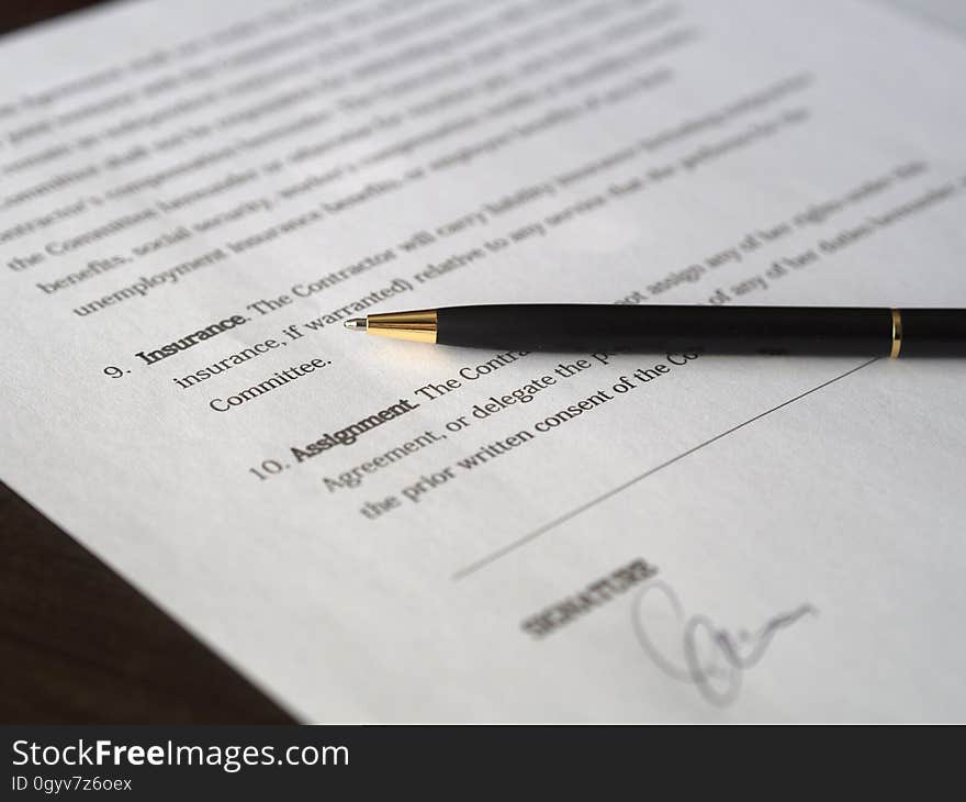 An agreement signed with a pen on top. An agreement signed with a pen on top.