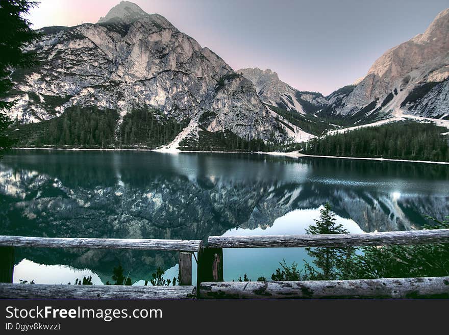 A view of a lake with a mountain range in the horizon. A view of a lake with a mountain range in the horizon.