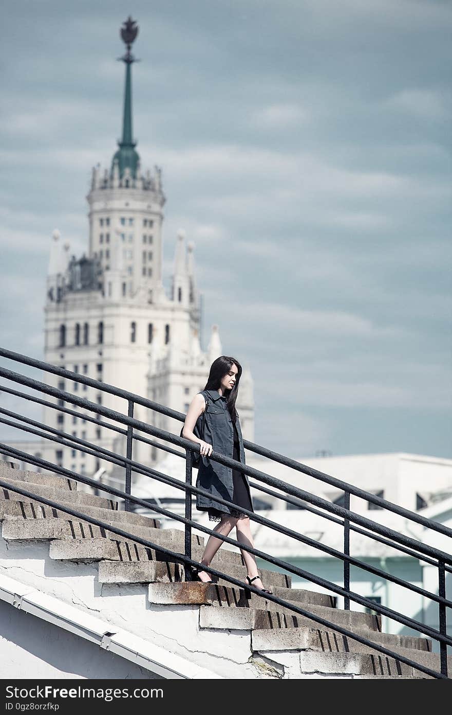 A woman walking down the stairs in a city. A woman walking down the stairs in a city.