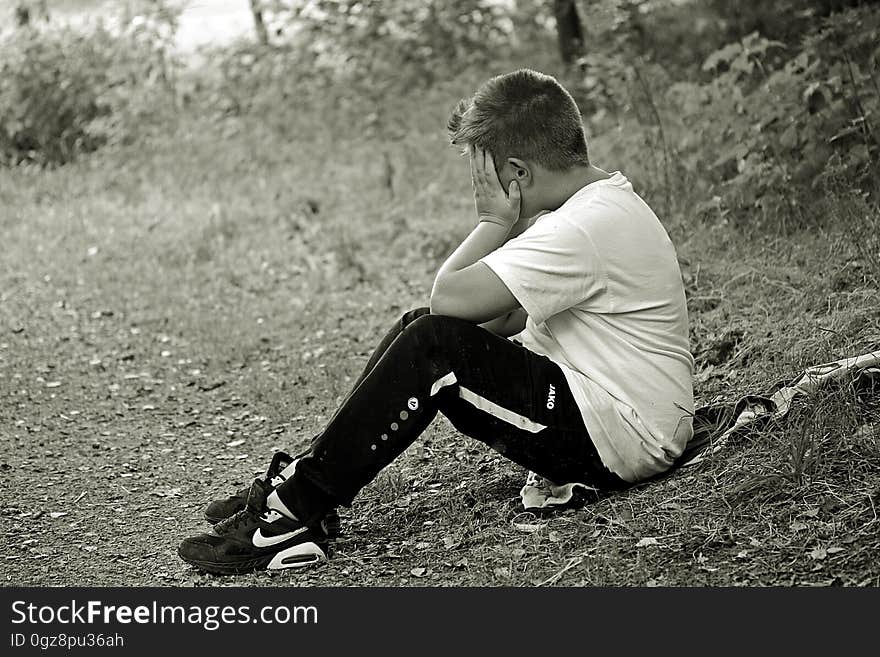 Boy in White Shirt and Black Track Pants