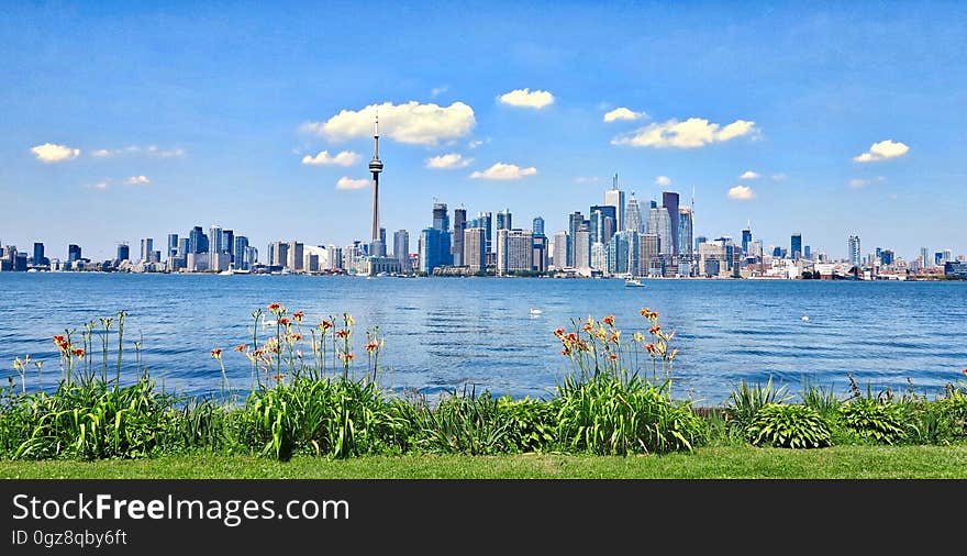 Skyline panorama of Toronto, Canada over blue waterfront on sunny day. Skyline panorama of Toronto, Canada over blue waterfront on sunny day.