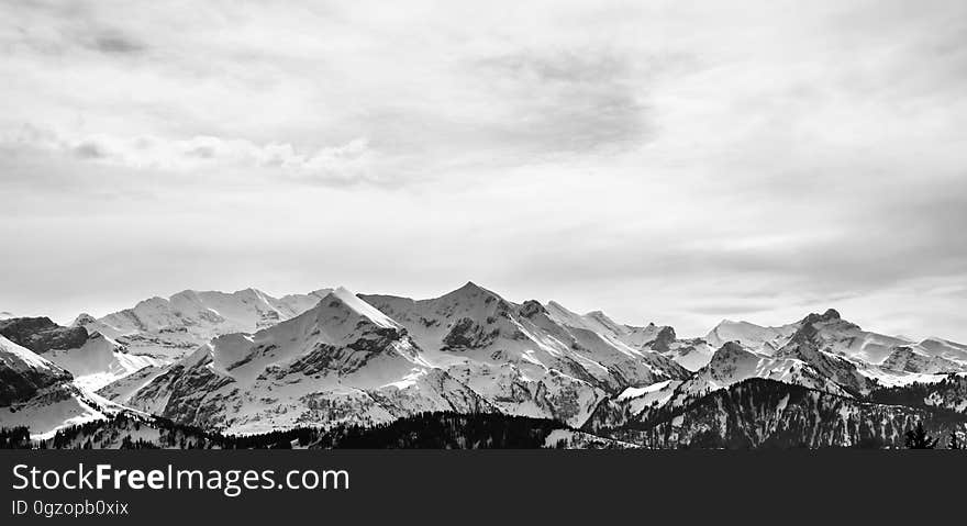 Panorama of snow covered mountain range landscape in black and white with copy space. Panorama of snow covered mountain range landscape in black and white with copy space.