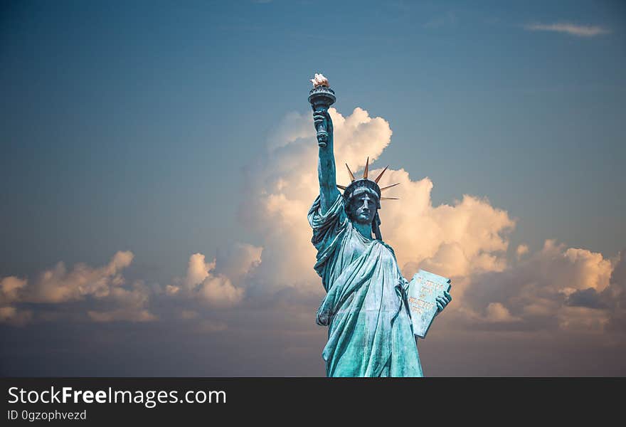 Statue of Liberty against blue skies with white clouds. Statue of Liberty against blue skies with white clouds.