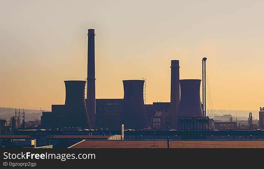 An industrial power plant at sunset.