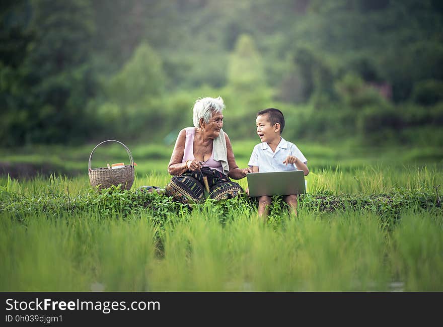 Old Woman Sitting Beside Her Grandson