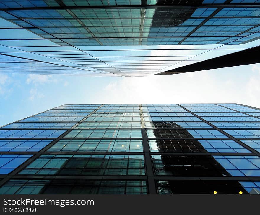 Glass and steel modern buildings from low angle against blue skies. Glass and steel modern buildings from low angle against blue skies.