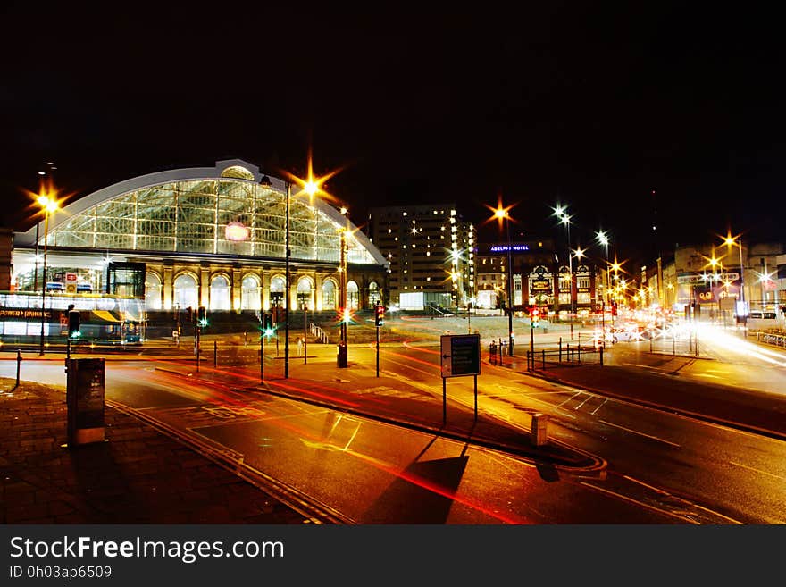 Train station on city streets illuminated at night. Train station on city streets illuminated at night.