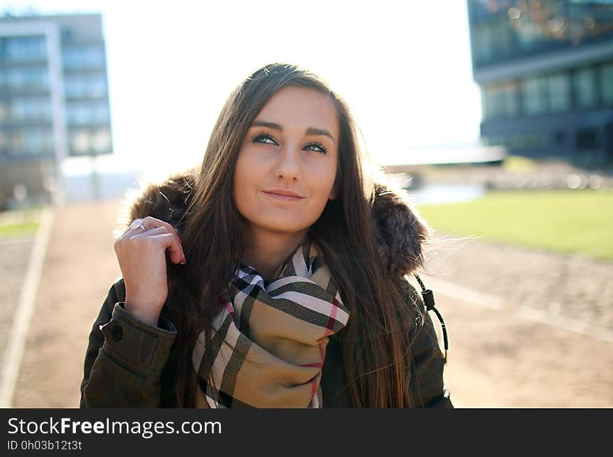 A woman walking on a street in a bright sunlight. A woman walking on a street in a bright sunlight.