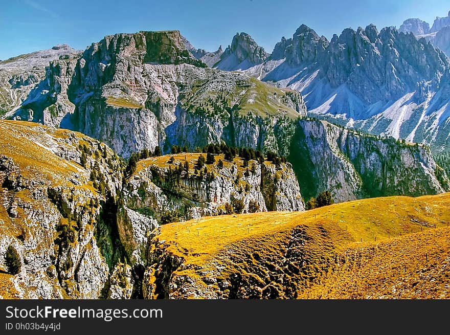 A landscape with rocky hills and mountain range. A landscape with rocky hills and mountain range.