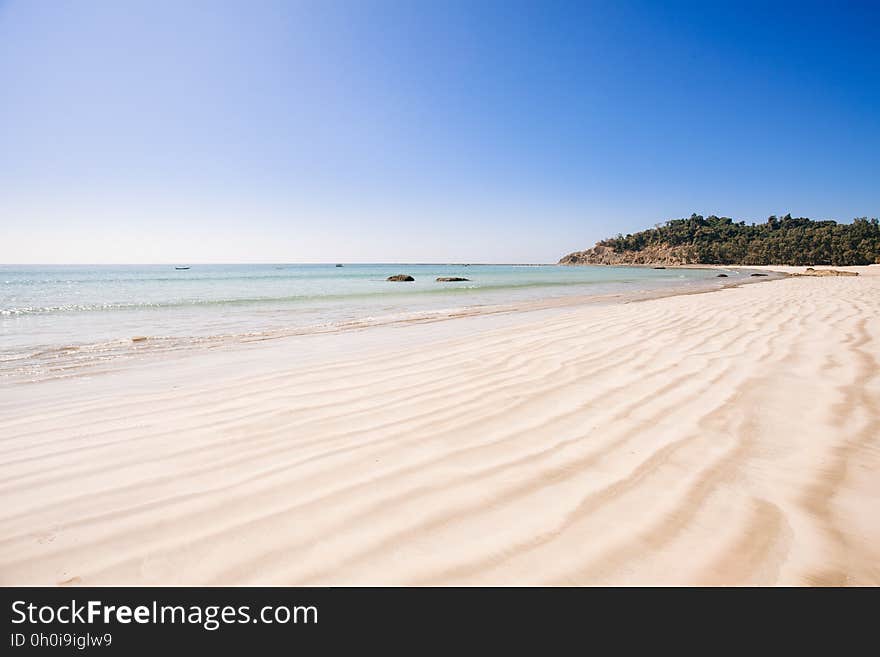 An empty beach with sand patterns. An empty beach with sand patterns.