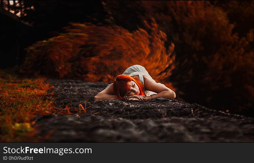 Woman in White Tank Dress Lying on Ground