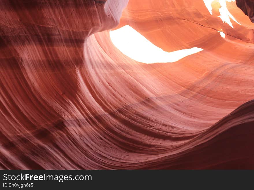 Abstract textured background created by red sandstone canyon eroded by river or stream.