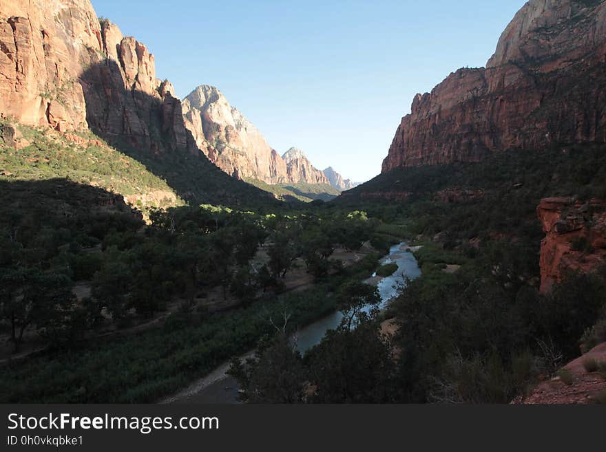 A view of a river flowing through a canyon. A view of a river flowing through a canyon.