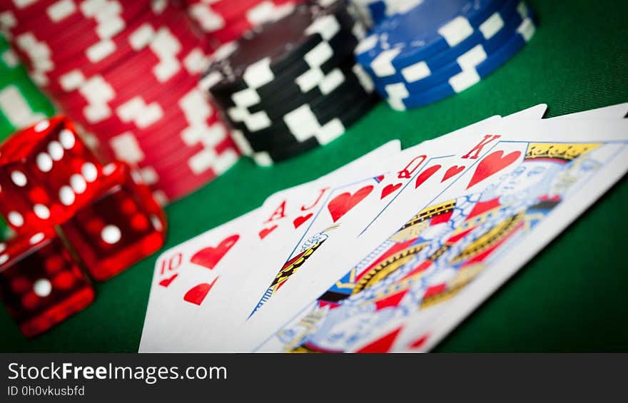 Cards forming a flush on a table with poker chips. Cards forming a flush on a table with poker chips.