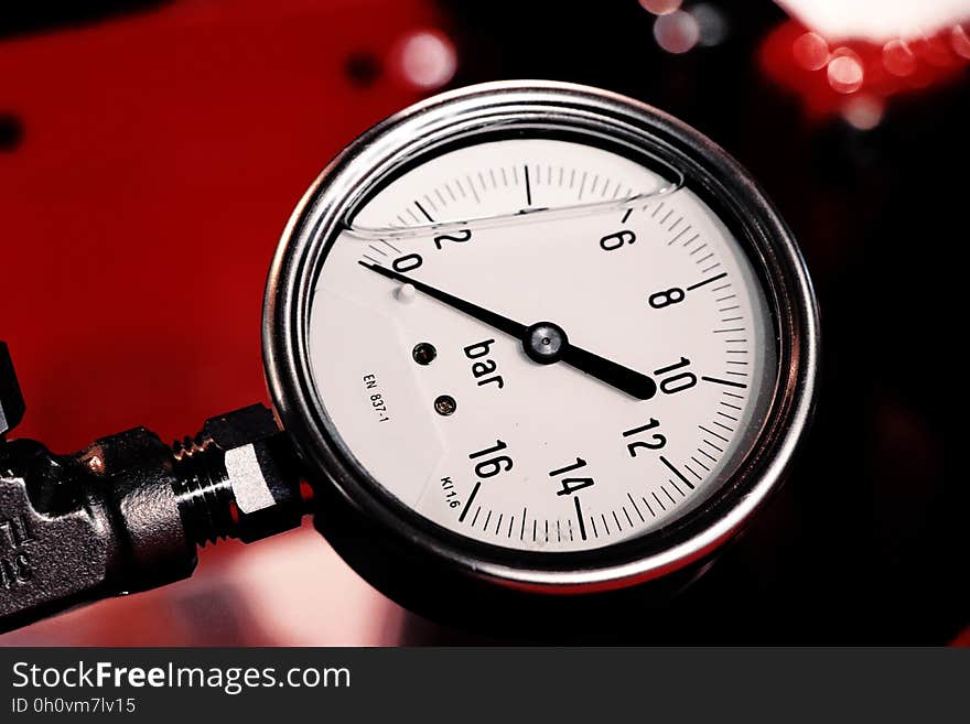 Close up of dial on face of pressure gauge.