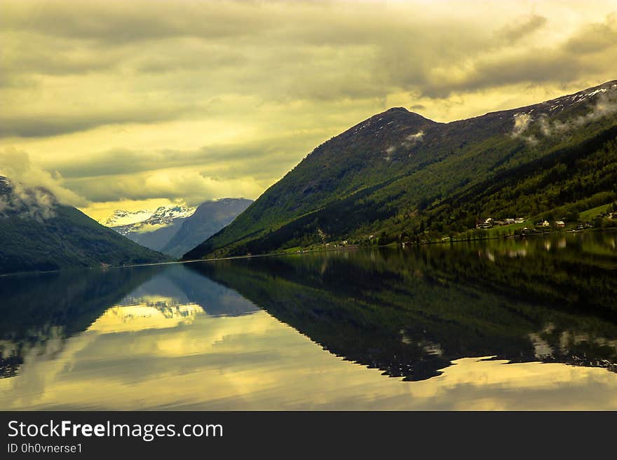 A landscape with mountains and the sky reflecting from a lake. A landscape with mountains and the sky reflecting from a lake.